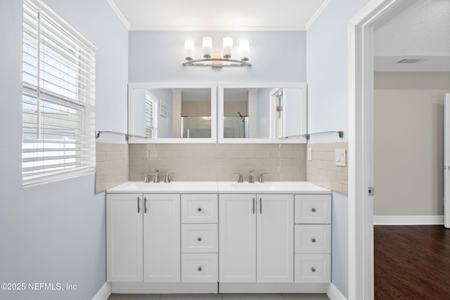 bathroom with ornamental molding, vanity, and decorative backsplash