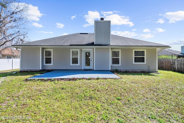 rear view of house with a yard and a patio area