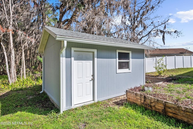 view of outbuilding with a yard