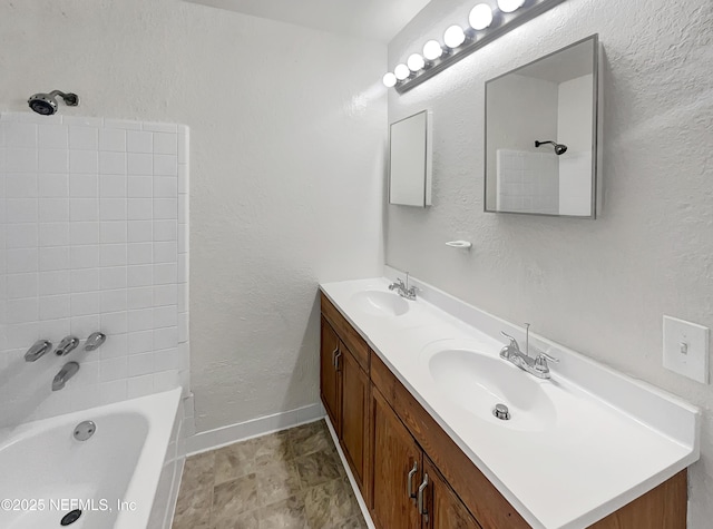 bathroom featuring vanity and tiled shower / bath