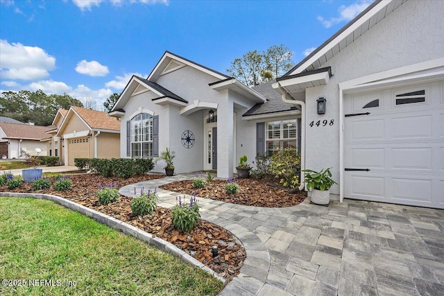 view of front of home featuring an attached garage and stucco siding