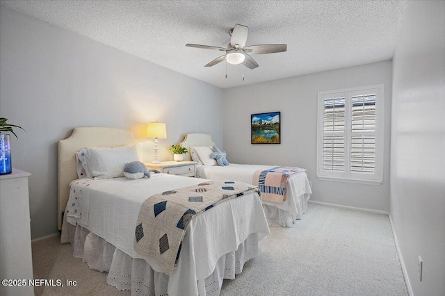 bedroom with light carpet, ceiling fan, baseboards, and a textured ceiling