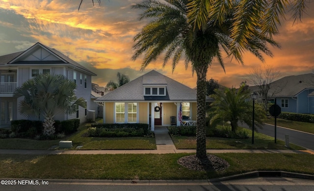 view of front of house with a porch and a lawn