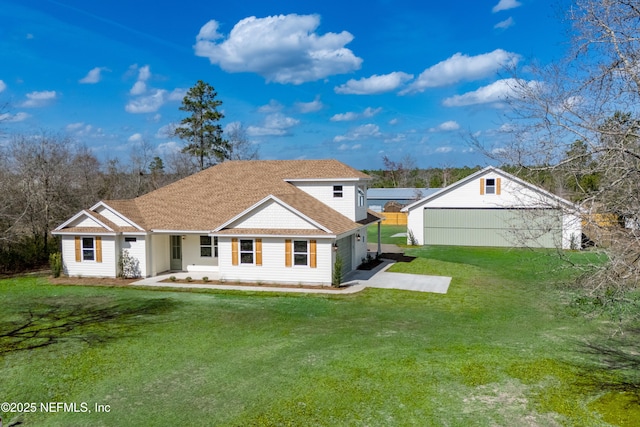 rear view of property with a garage and a lawn