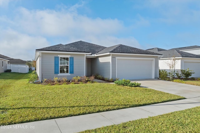 view of front of house featuring a garage and a front yard