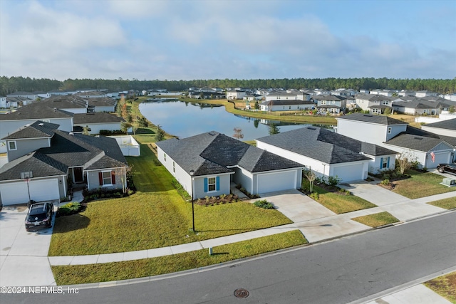 birds eye view of property with a water view