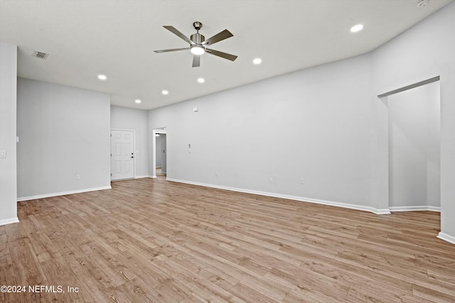 unfurnished living room featuring ceiling fan and light wood-type flooring