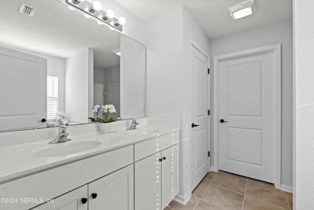 bathroom with tile patterned floors and vanity