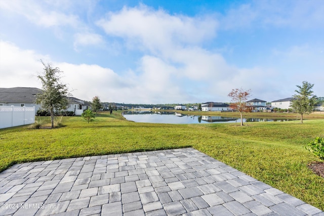 view of community with a water view and a yard