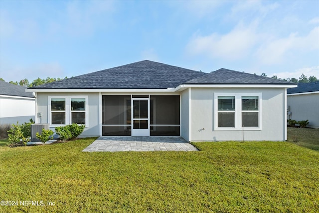 rear view of house featuring central AC unit, a yard, and a patio