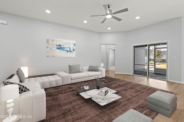 living room with hardwood / wood-style floors and ceiling fan