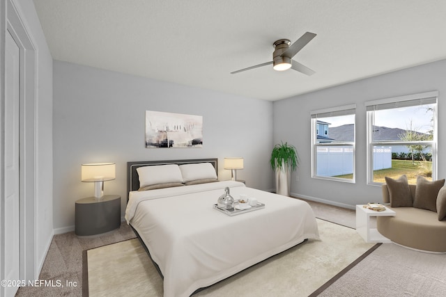 bedroom with ceiling fan and carpet