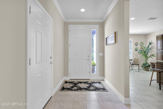 tiled foyer entrance featuring ornamental molding