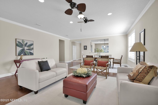 living room with crown molding, ceiling fan, and hardwood / wood-style floors