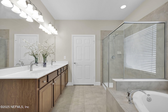 bathroom featuring tile patterned flooring, vanity, and separate shower and tub