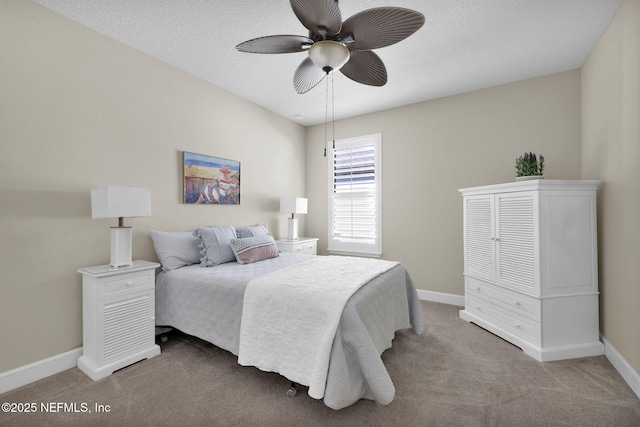 carpeted bedroom featuring a textured ceiling and ceiling fan