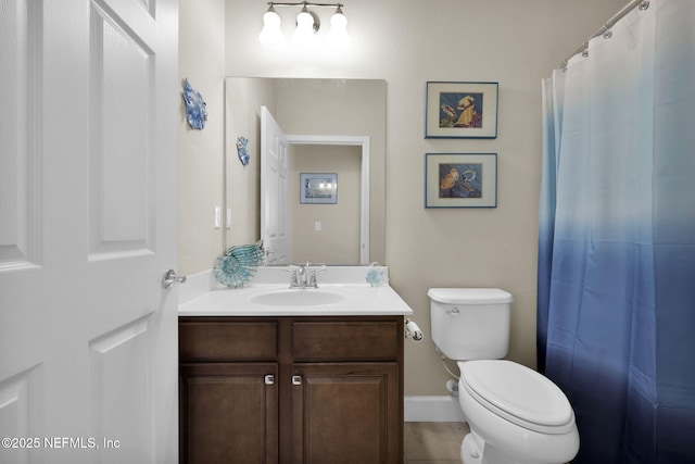 bathroom featuring tile patterned floors, vanity, and toilet