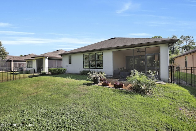 back of house with a yard and a sunroom