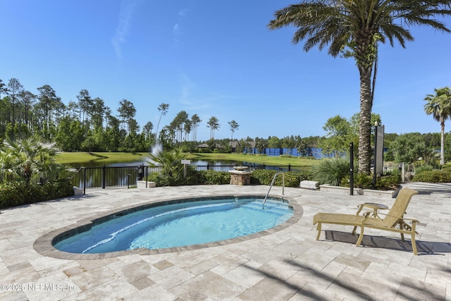 view of swimming pool featuring a patio area and a water view