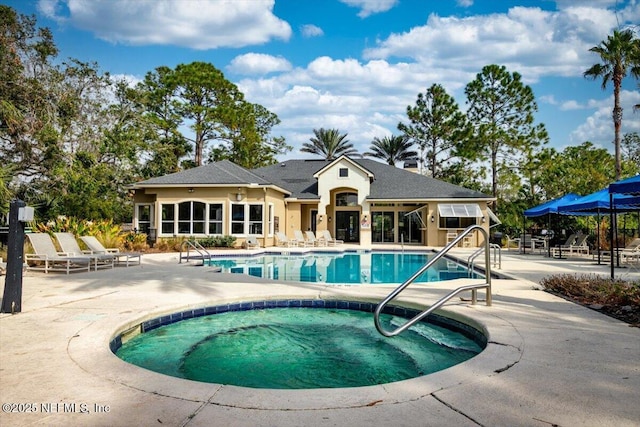 view of pool featuring a community hot tub and a patio