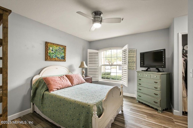 bedroom with ceiling fan and light hardwood / wood-style flooring