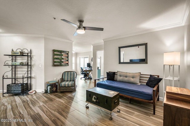 living room with ceiling fan, ornamental molding, hardwood / wood-style floors, and a textured ceiling