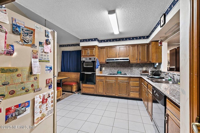 kitchen with a textured ceiling, black appliances, backsplash, light tile patterned floors, and sink