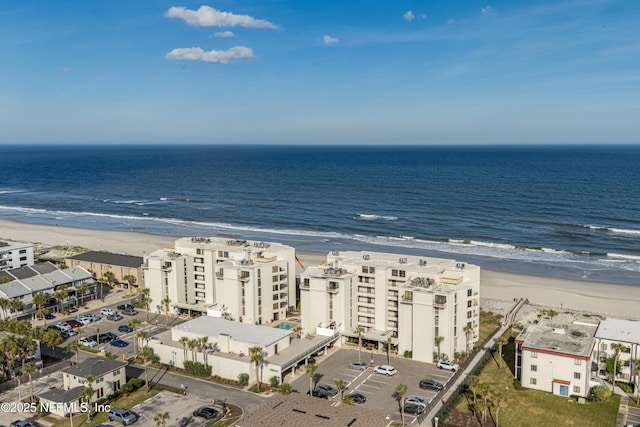 birds eye view of property with a water view and a view of the beach