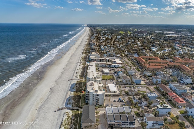 birds eye view of property with a beach view and a water view