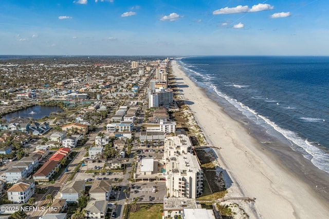 drone / aerial view featuring a view of the beach and a water view