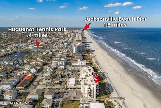 birds eye view of property with a view of the beach and a water view