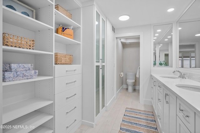 bathroom featuring vanity, hardwood / wood-style floors, and toilet