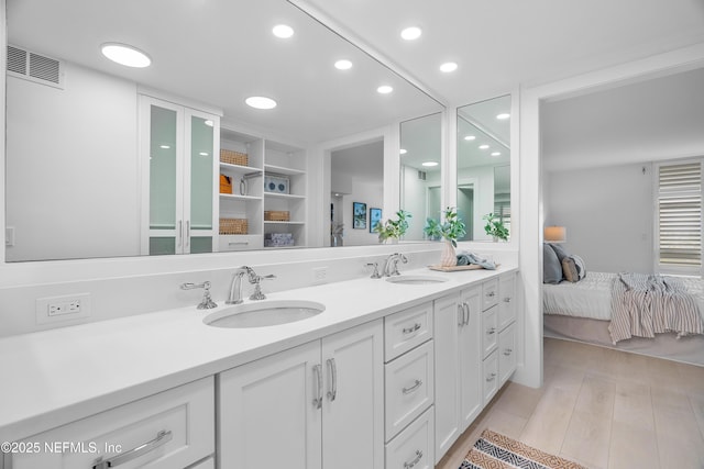 bathroom with hardwood / wood-style flooring and vanity
