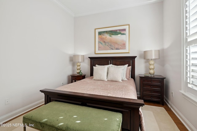 bedroom with dark hardwood / wood-style flooring and crown molding