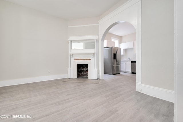 unfurnished living room with light wood-type flooring