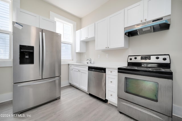 kitchen featuring sink, light hardwood / wood-style flooring, white cabinets, and appliances with stainless steel finishes