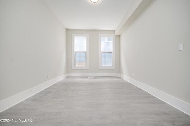 empty room with light hardwood / wood-style flooring