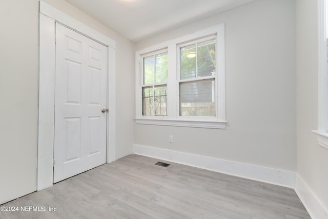 unfurnished bedroom with light wood-type flooring