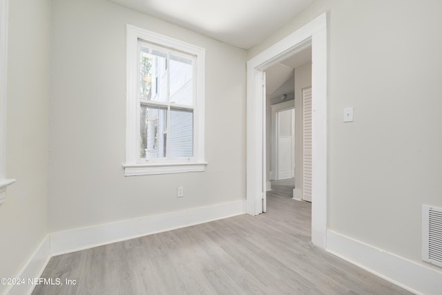 unfurnished room with light wood-type flooring