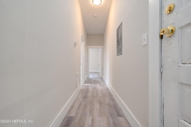 corridor featuring light hardwood / wood-style floors