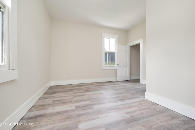 spare room featuring light hardwood / wood-style flooring