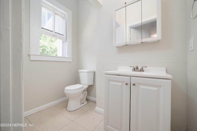 bathroom with vanity, tile patterned floors, and toilet