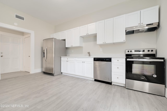 kitchen featuring stainless steel appliances, light wood-type flooring, and white cabinets