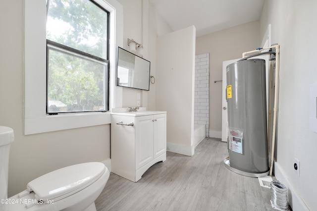 bathroom with curtained shower, hardwood / wood-style flooring, vanity, toilet, and electric water heater