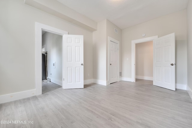 empty room with light hardwood / wood-style flooring