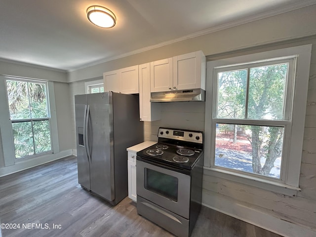 kitchen featuring stainless steel appliances, a wealth of natural light, light hardwood / wood-style floors, and white cabinets