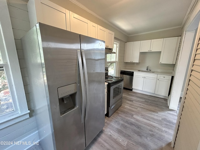 kitchen with sink, white cabinetry, light wood-type flooring, ornamental molding, and appliances with stainless steel finishes