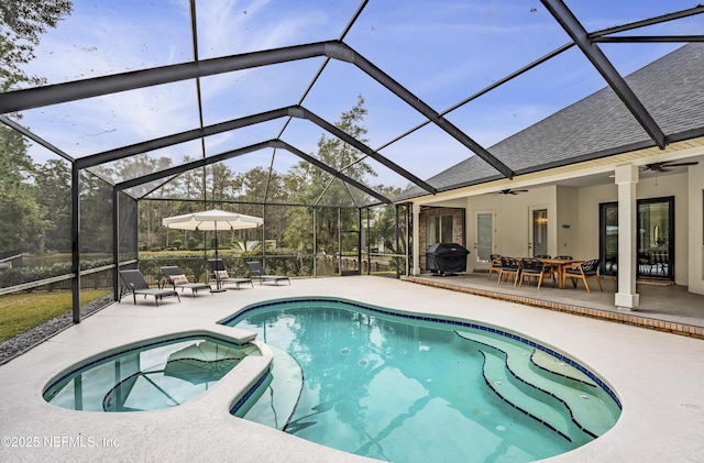 view of pool featuring ceiling fan, a patio area, and glass enclosure