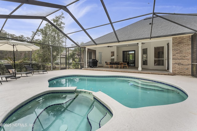 view of swimming pool featuring a lanai, ceiling fan, and a patio area