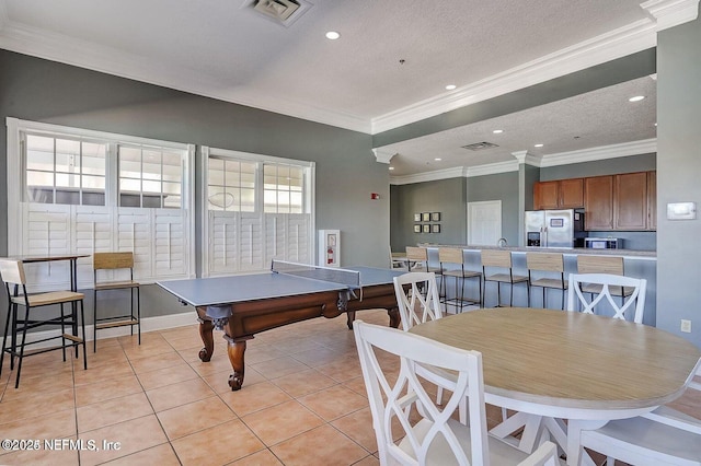 playroom with light tile patterned floors, a textured ceiling, recessed lighting, visible vents, and crown molding